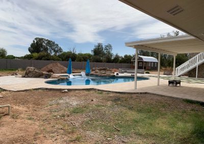 Rrolled bond beam to travertine cap and two rows of tile And chip and mini pebble - Refurbished the slide Grotto water feature